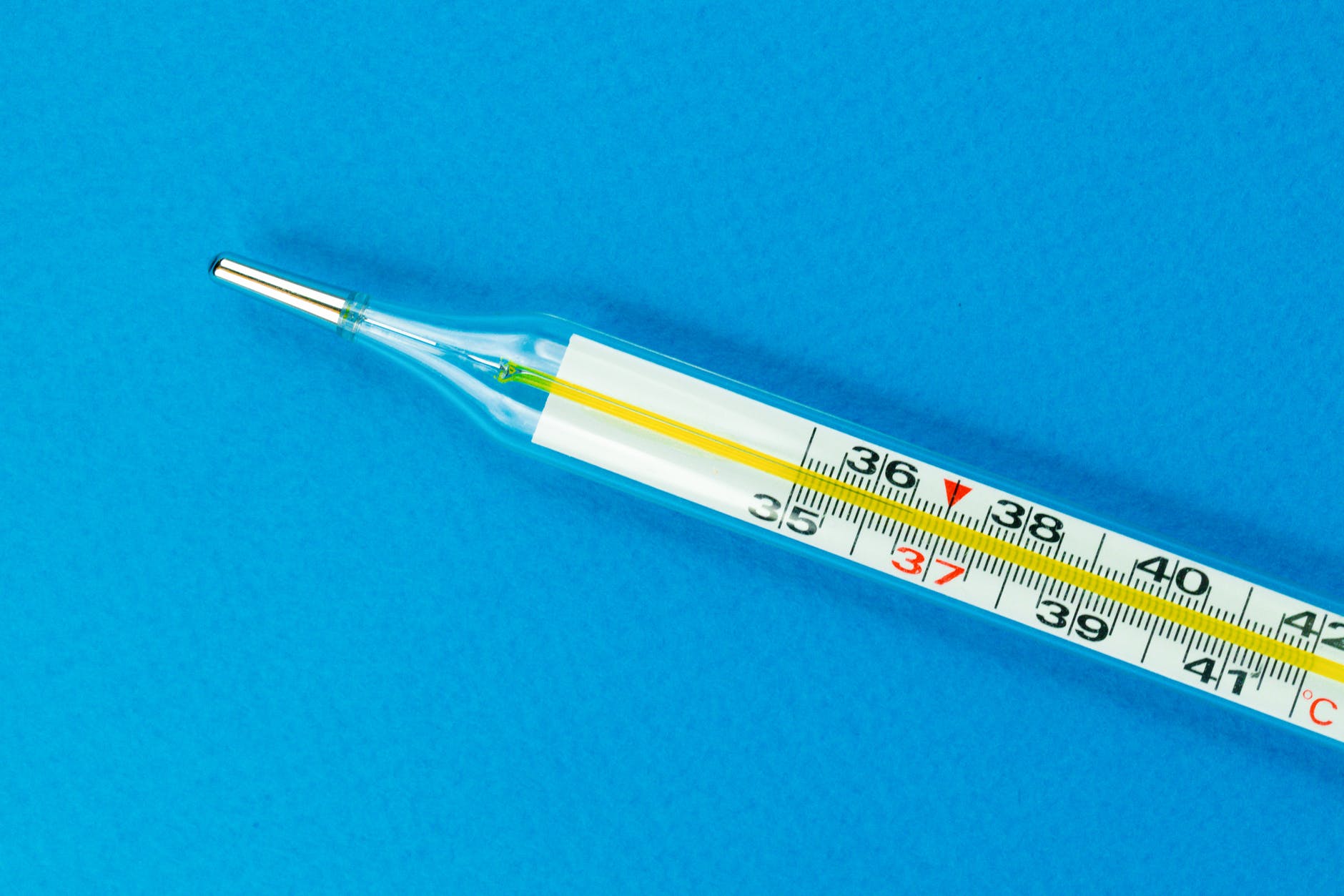 white and yellow thermometer on blue textile
